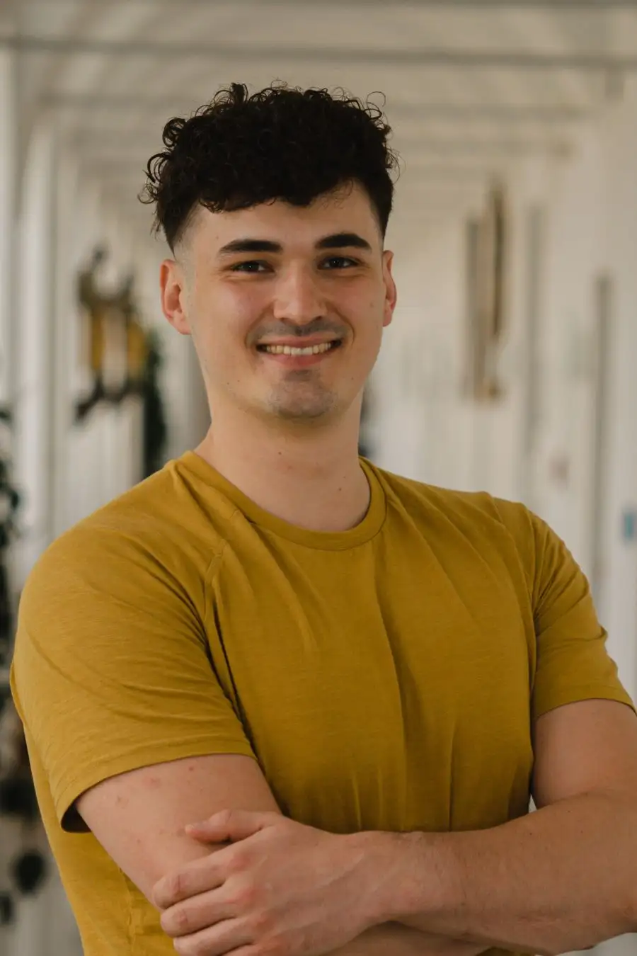 Ing. Dominik Stefan Pototschnig, MSc. wearing a yellow T-shirt, with his arms crossed
