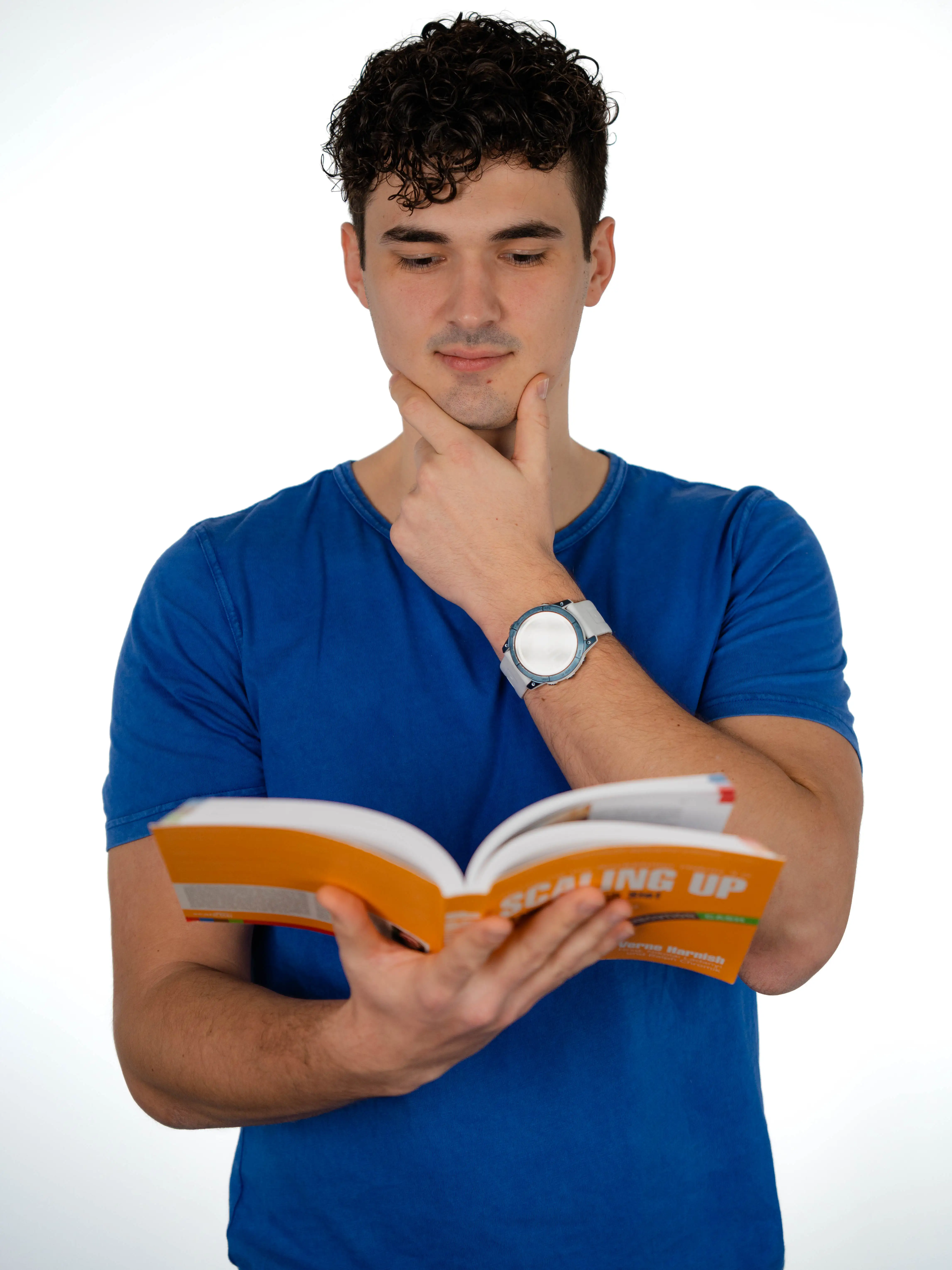 Dominik Pototschnig in a blue T-shirt reading against a white background