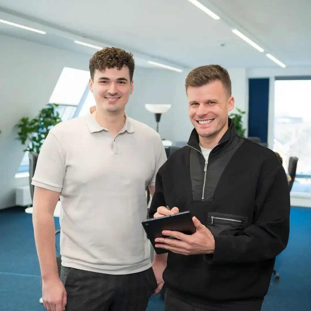 Dominik Pototschnig and Florian Semmler standing in an office with a tablet